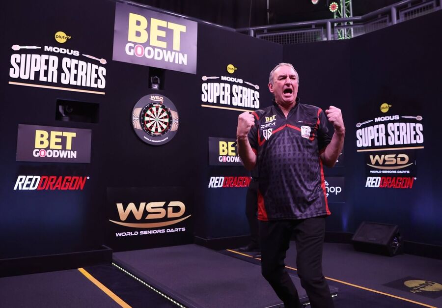 Richie Burnett slaví vítězství u&nbsp;šipkařského terče během turnaje Modus Super Series